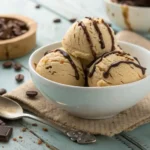 Bowl of creamy coffee ice cream with chocolate drizzle