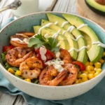 Grilled shrimp bowl with avocado, corn salsa, and garlic sauce