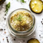 Homemade pickle salt in a jar with dried pickle slices