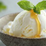 Creamy cottage cheese ice cream in a bowl with honey and mint