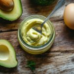 Jar of homemade mayonnaise with avocado oil on rustic table
