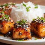 Crispy honey garlic salmon bites served on a white plate