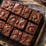 Gooey melty Mars Cake cut into squares on baking tray