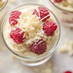 White chocolate raspberry cream dessert in glass cups