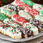Festive white chocolate-dipped sugar wafers with holiday sprinkles