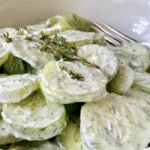 Creamy cucumber salad with dill in ceramic bowl