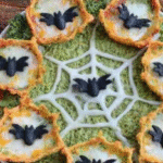 Spooky Halloween-themed food table with festive treats