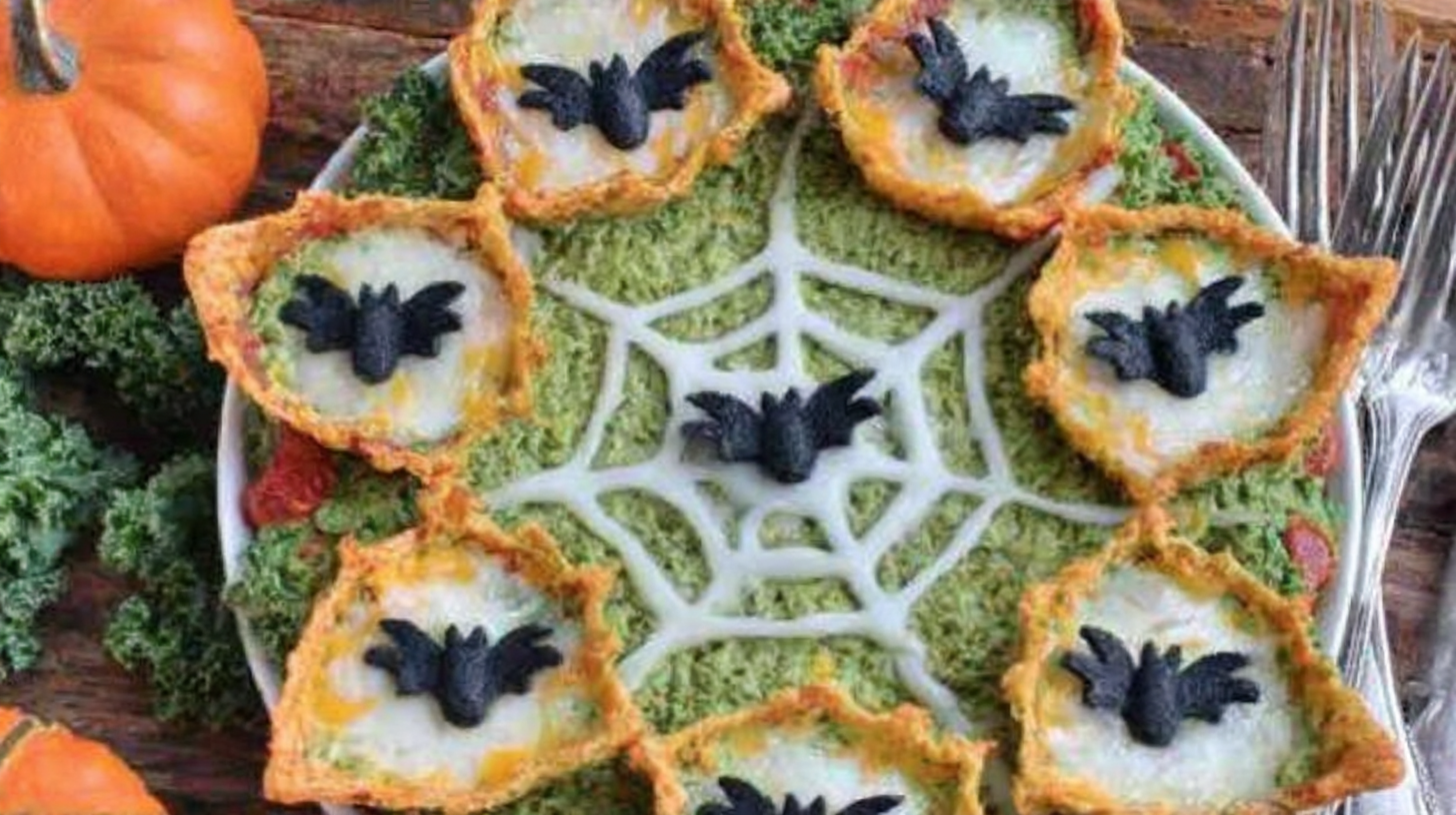 Spooky Halloween-themed food table with festive treats