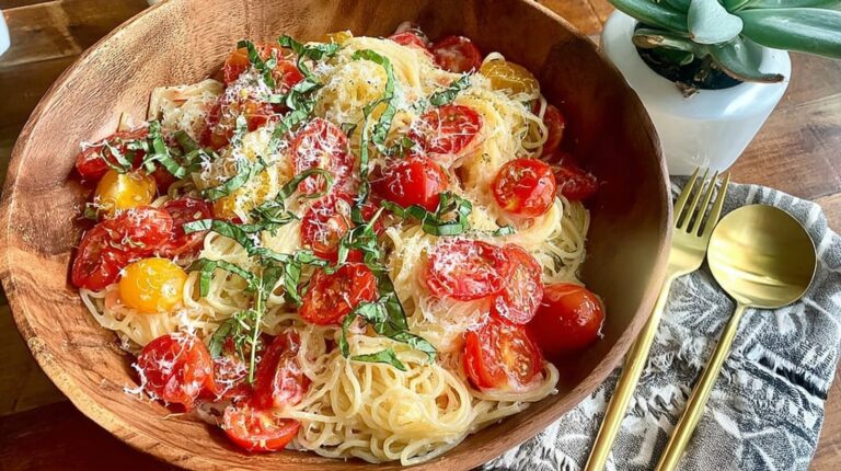 Summer garden pasta with fresh tomatoes and basil on rustic plate