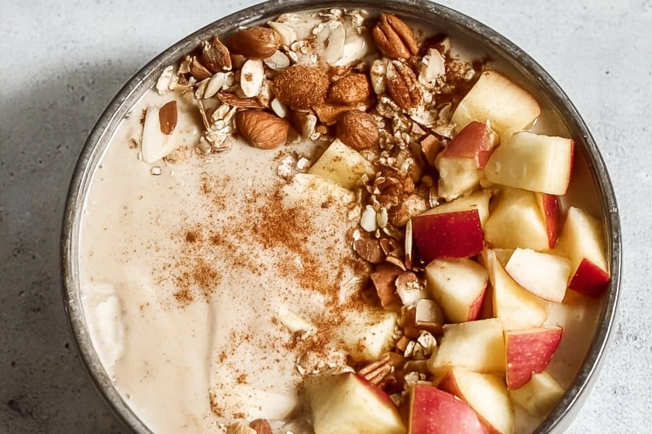 Delicious apple smoothie bowl topped with fresh fruits and nuts