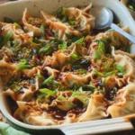 Delicious Belly Full Thai Dumpling Casserole topped with fresh herbs and spices.