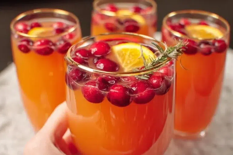 Festive Christmas Morning Punch in a beautiful serving bowl with garnishes