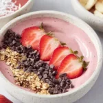 Creamy smoothie bowl topped with fresh fruits and seeds