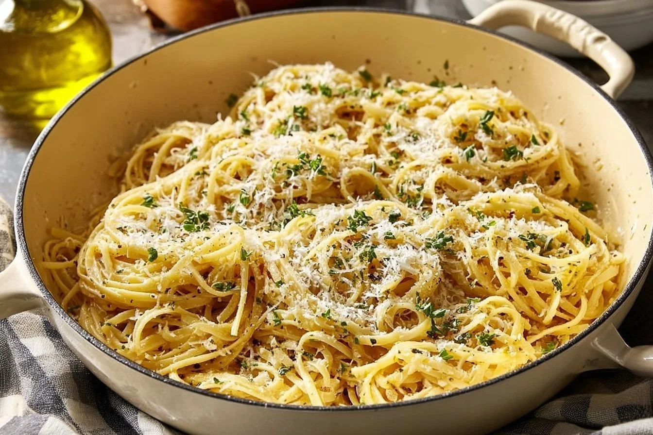 A plate of easy garlic butter pasta garnished with parsley and parmesan cheese