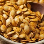 Bowl of delicious roasted pumpkin seeds, perfect fall snack