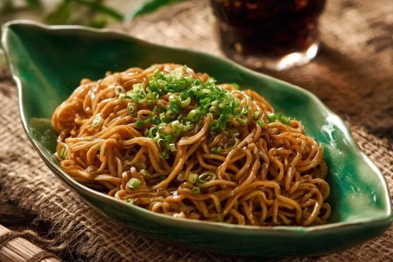 Plate of Triple Garlic Noodles garnished with herbs