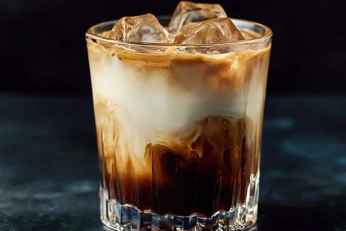 Delicious White Russian cocktail served in a glass with ice cubes.