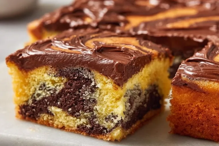 Delicious Chocolate Poke Cake topped with chocolate frosting and sprinkles