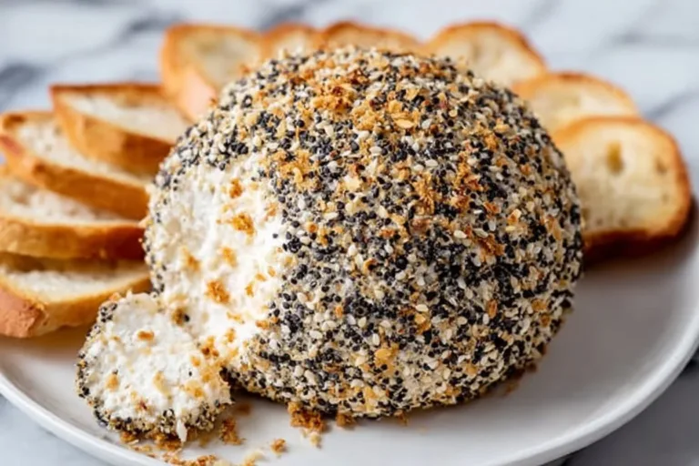 Delicious Everything Bagel Cheeseball topped with seasoning and served with crackers.
