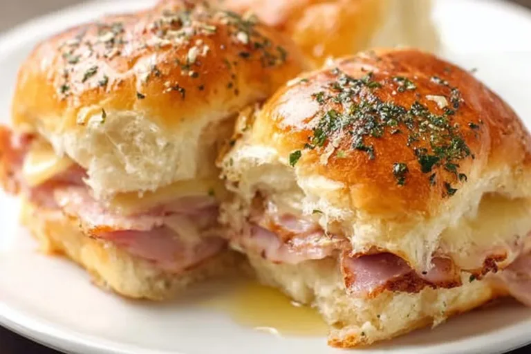 Delicious ham and cheese sliders served on a platter for a tasty snack.