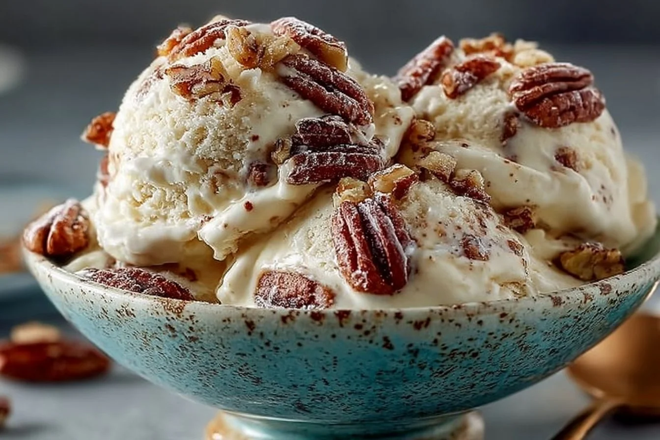 Bowl of homemade butter pecan ice cream with pecans on top