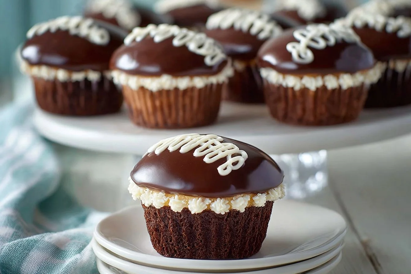 Homemade Hostess Cupcakes drizzled with chocolate and filled with cream.