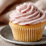 Delicious Lemon Raspberry Cupcakes with frosting and fresh raspberries on top