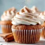 Delicious pumpkin cupcakes with cream cheese frosting on a decorative plate