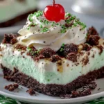 Layered Shamrock Shake Lasagna with green mint frosting and chocolate drizzle