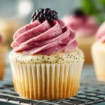 Freshly baked lemon poppy seed cupcakes with icing and lemon slices