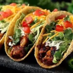 Delicious chicken tacos served with fresh toppings and vibrant ingredients.