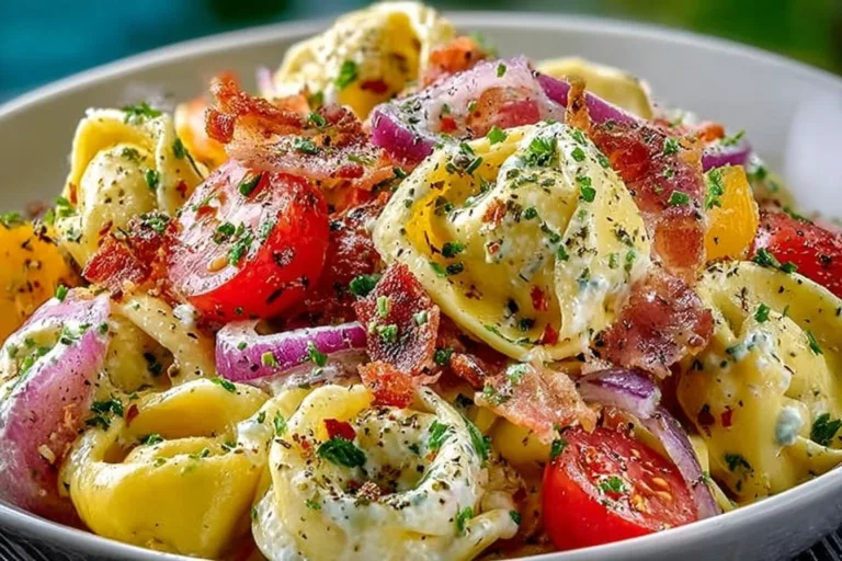 Colorful grinder tortellini salad with fresh vegetables and dressing