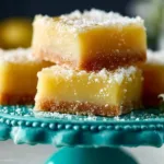 Delicious lemon bars with a buttery shortbread crust served on a plate.