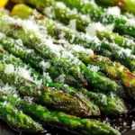 Lemon parmesan baked asparagus served on a white plate