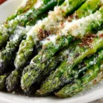 Plate of crispy oven-baked asparagus seasoned and ready to serve.